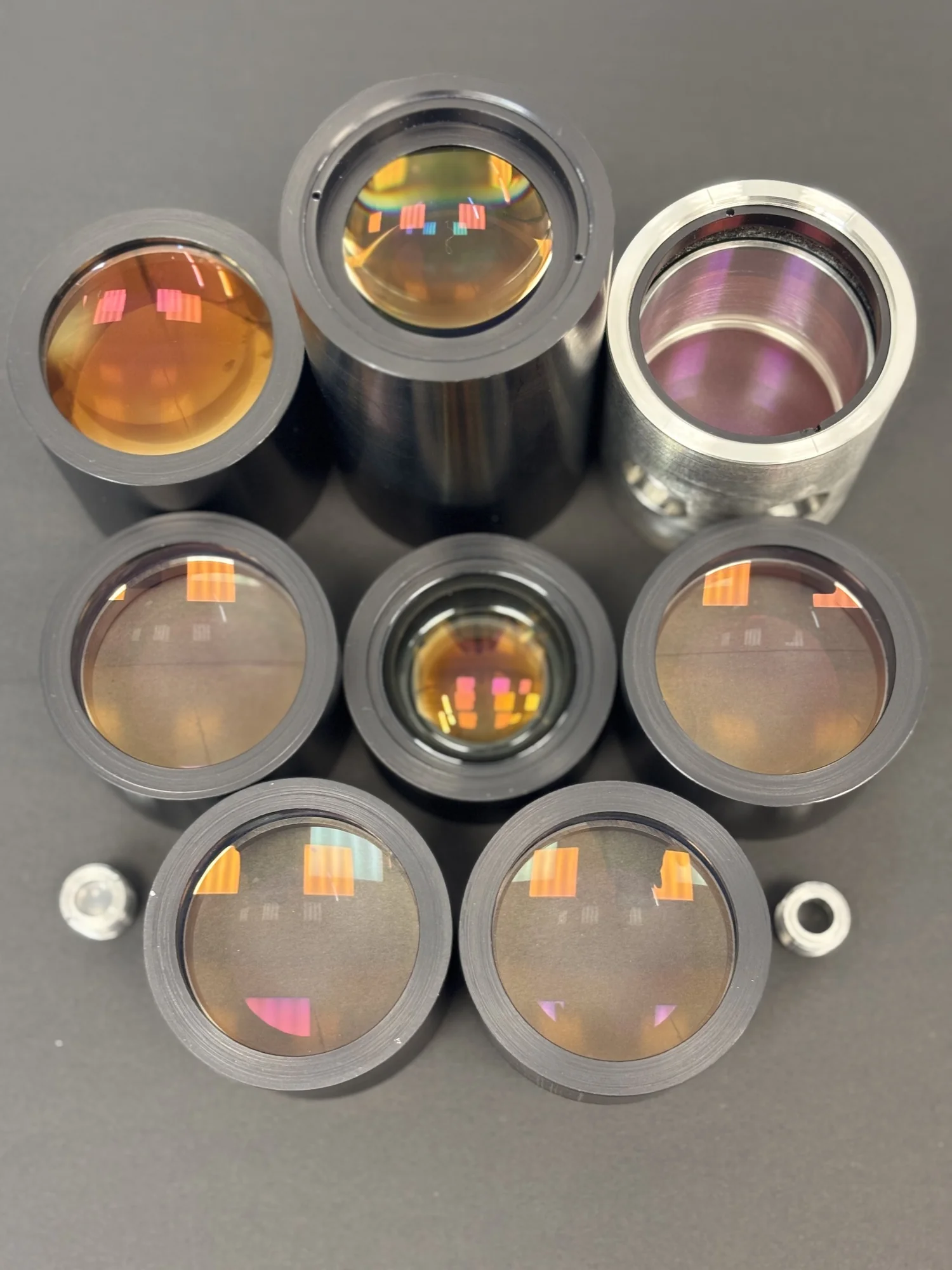 Lenses in metal mounts with anti-reflection coatings
